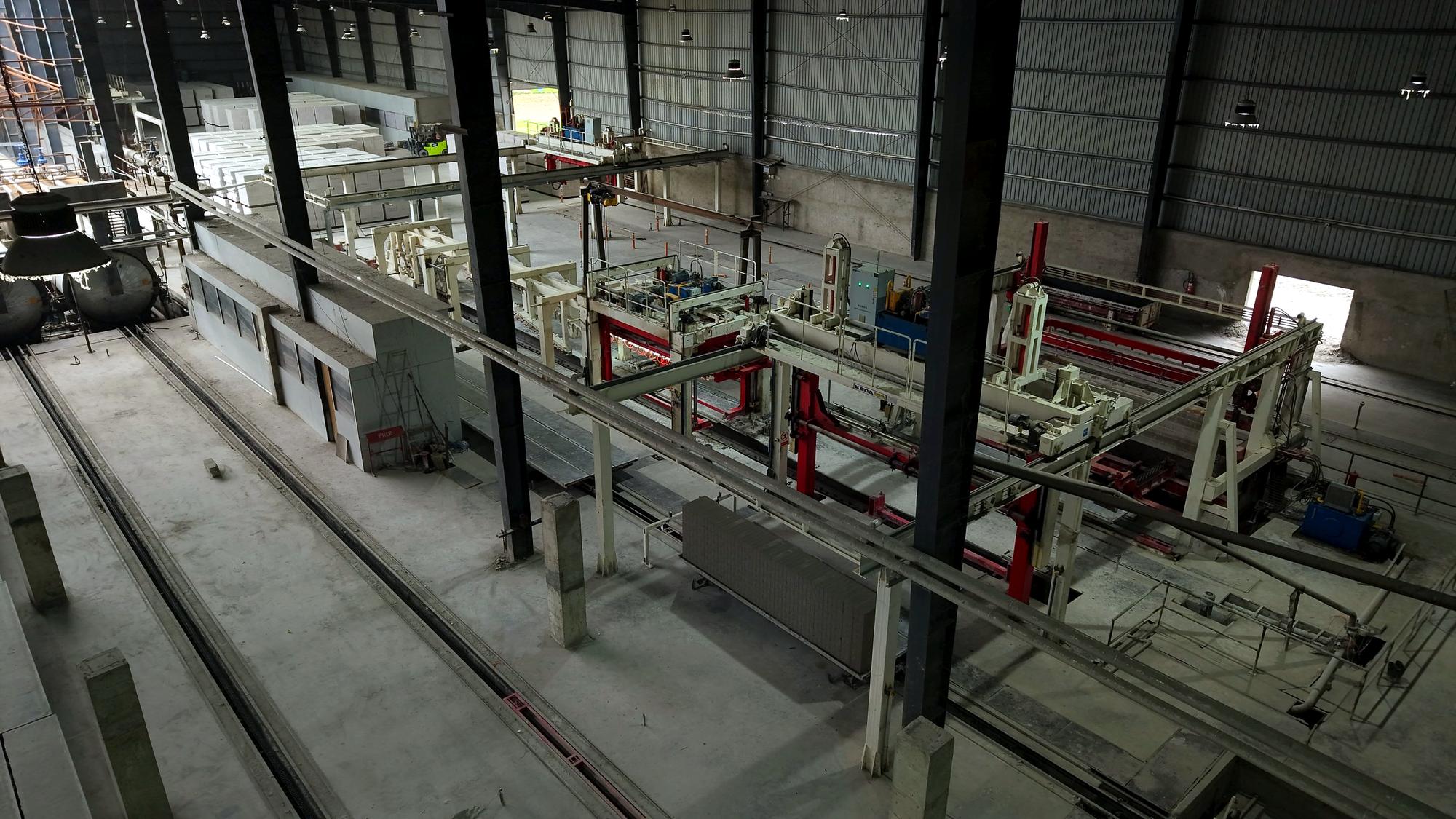 A full green cake on the cutting line beside the gantry
