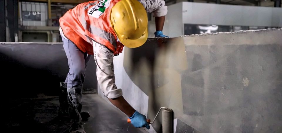 An operator oiling a mould before casting